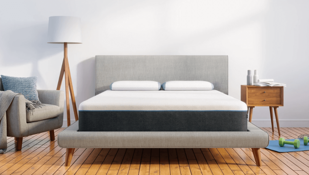 A gray and white Bear Pro mattress on a gray bed frame.