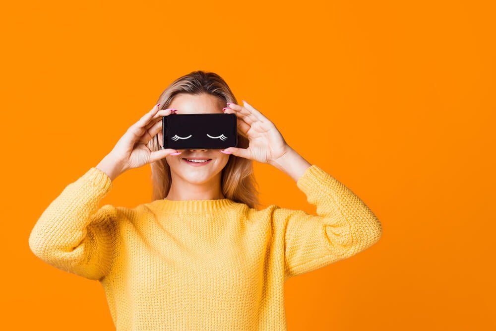 Digital detox, the icon of closed eyes on the smartphone screen, applications that help to observe the mode of the day, the concept.