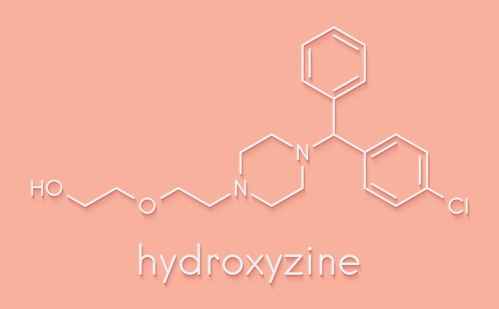 A white chemical outline of Hydroxyzine, or Vistaril, on a pink background.