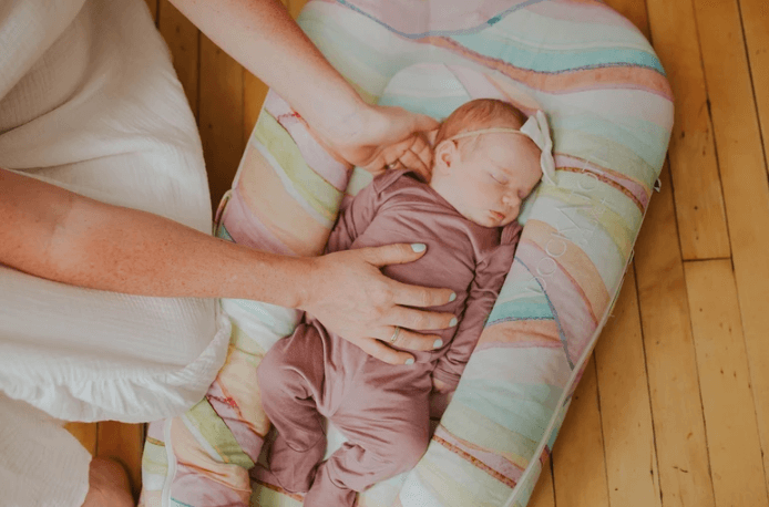A sleeping child in a lounger.