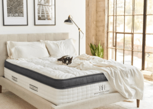 A white hybrid mattress in a bedroom.