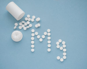 Magnesium symbols from pills on a blue background.