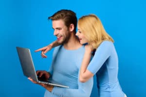 Online shopping. Online-shop. Smiling couple with laptop.