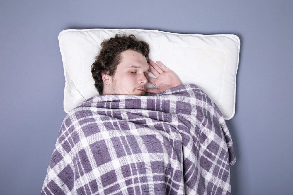 man sleeping in bed