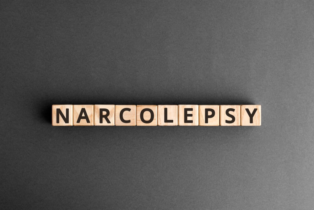 Brown blocks with black letters spelling "narcolepsy" against a black background.