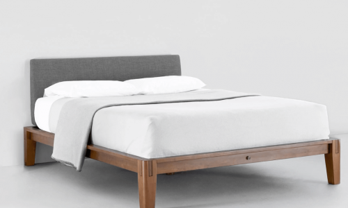 Thuma platform bed frame isolated against gray background.