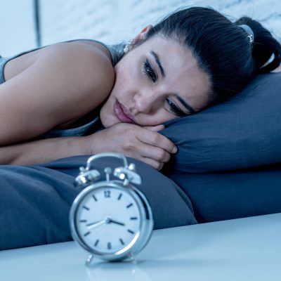 Young,Beautiful,Hispanic,Woman,At,Home,Bedroom,Lying,In,Bed