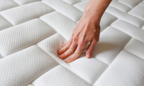 Cropped,Shot,Of,Young,Woman's,Hand,Testing,White,Orthopedic,Mattress